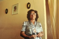 Ester Herrarte stands in the living room where her son Jorge, in the photograph, was abducted in 1983.