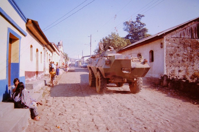 Army tank drives down street in Santiago Atitlán, 1987.