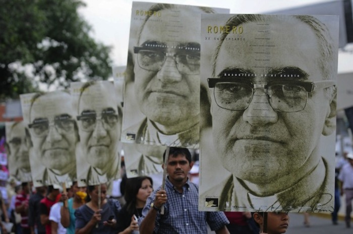 People carry large portraits of Salvadoran Archbishop Oscar Romero during rally in his honor in San Salvador